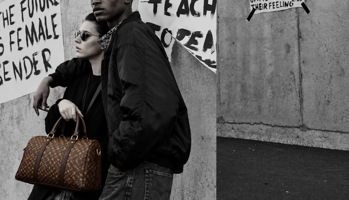 Two models showcasing leather bags